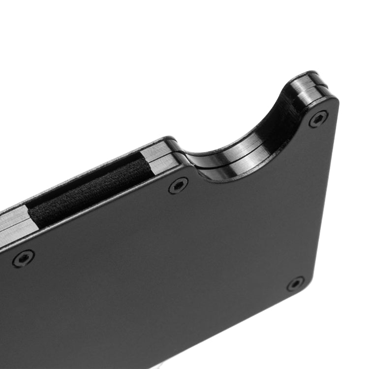 Close-up of a metallic object with a black component on a white background